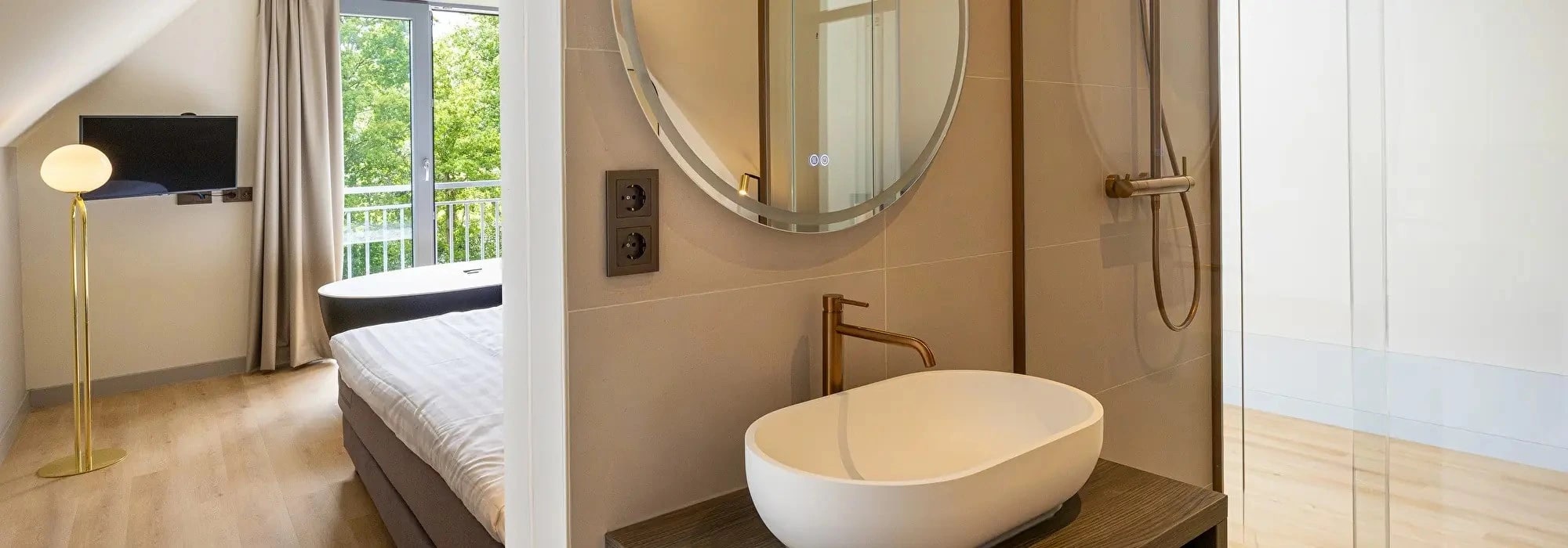 Comfortabele kamer met ronde spiegel en warme tinten